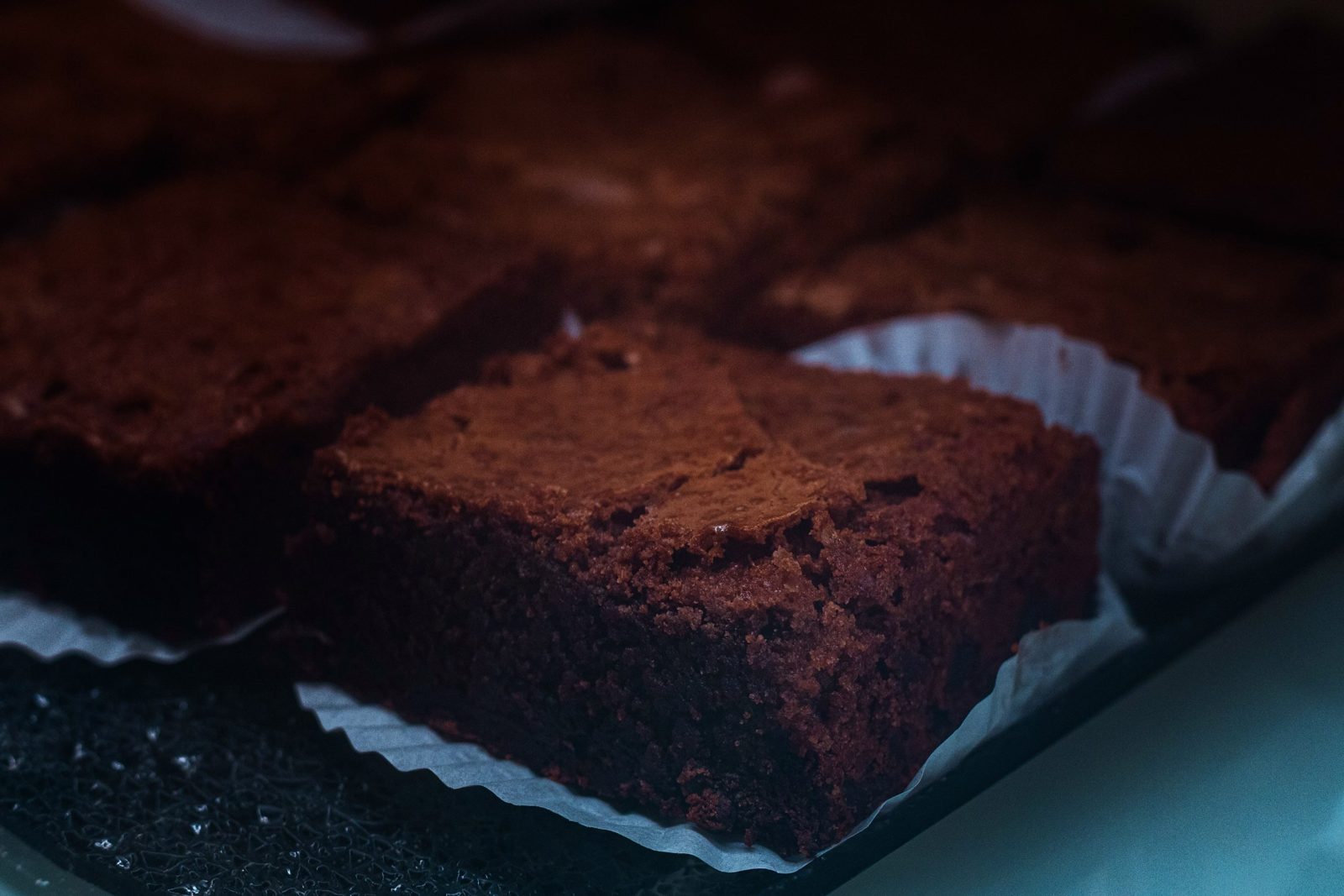 Dark chocolate brownies in paper cases at La Sucrière pâtisserie